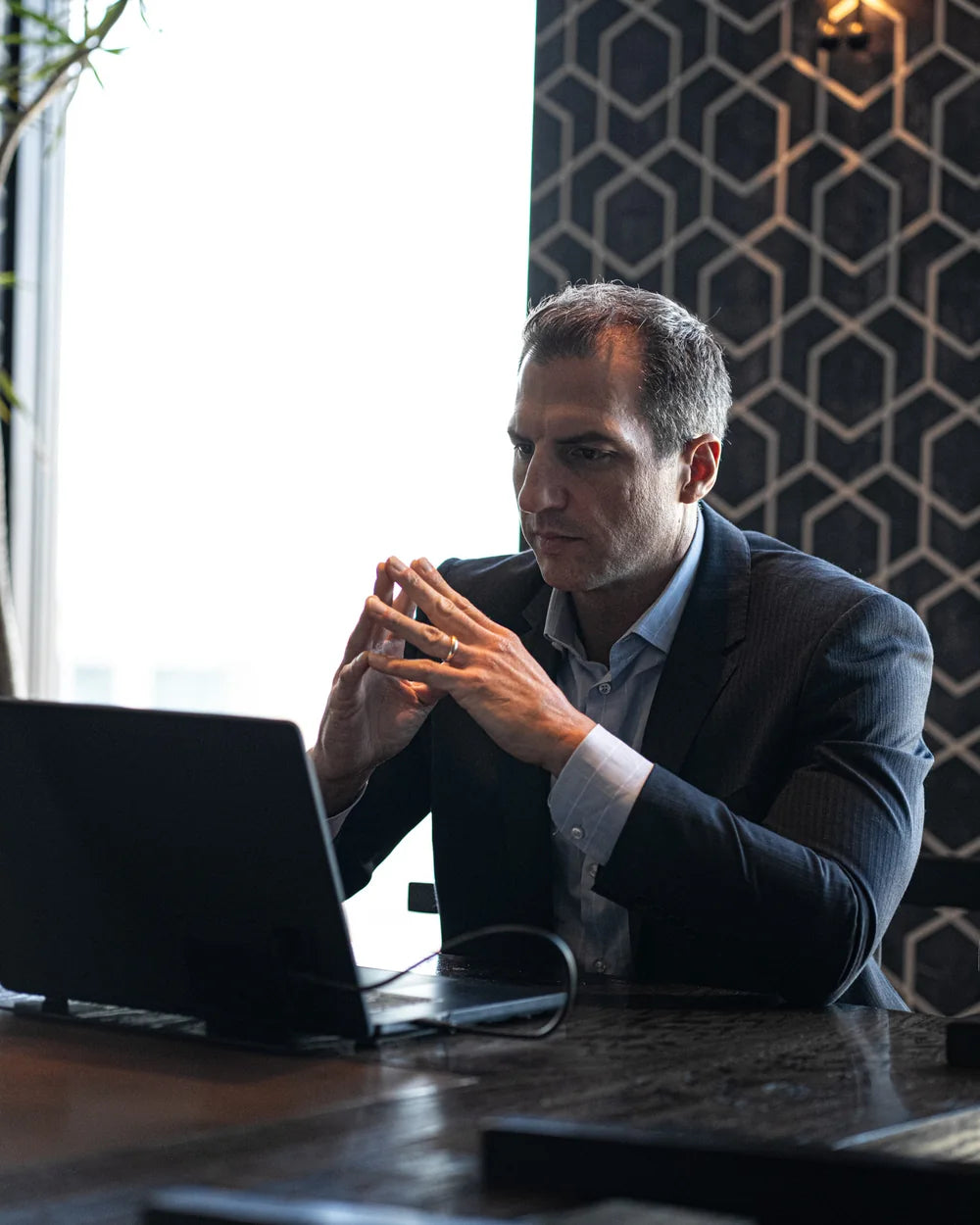 Matt Balzano working at a laptop in a private meeting setting