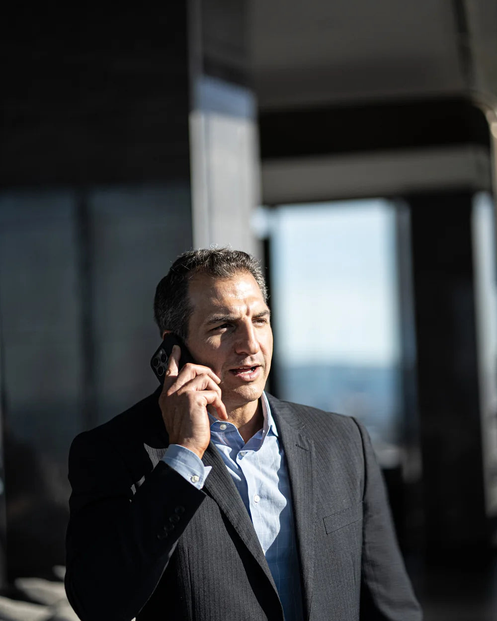 Matt Balzano speaking by phone near a window
