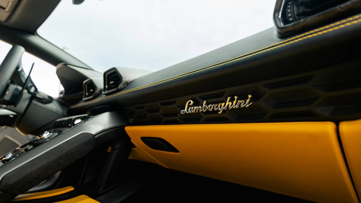Black and yellow sports-car interior with steering wheel and center controls