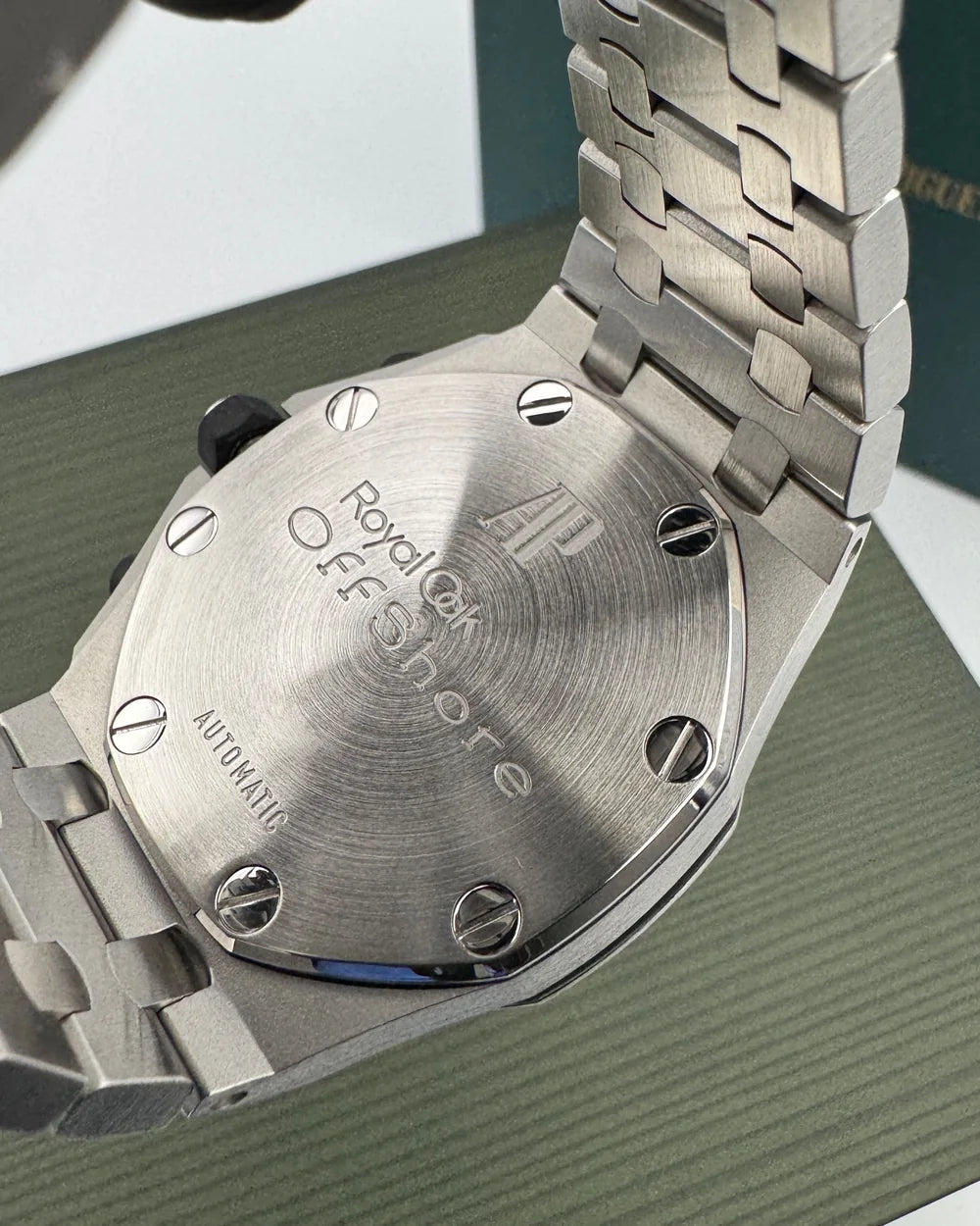 Close-up of the caseback and bracelet of a steel watch